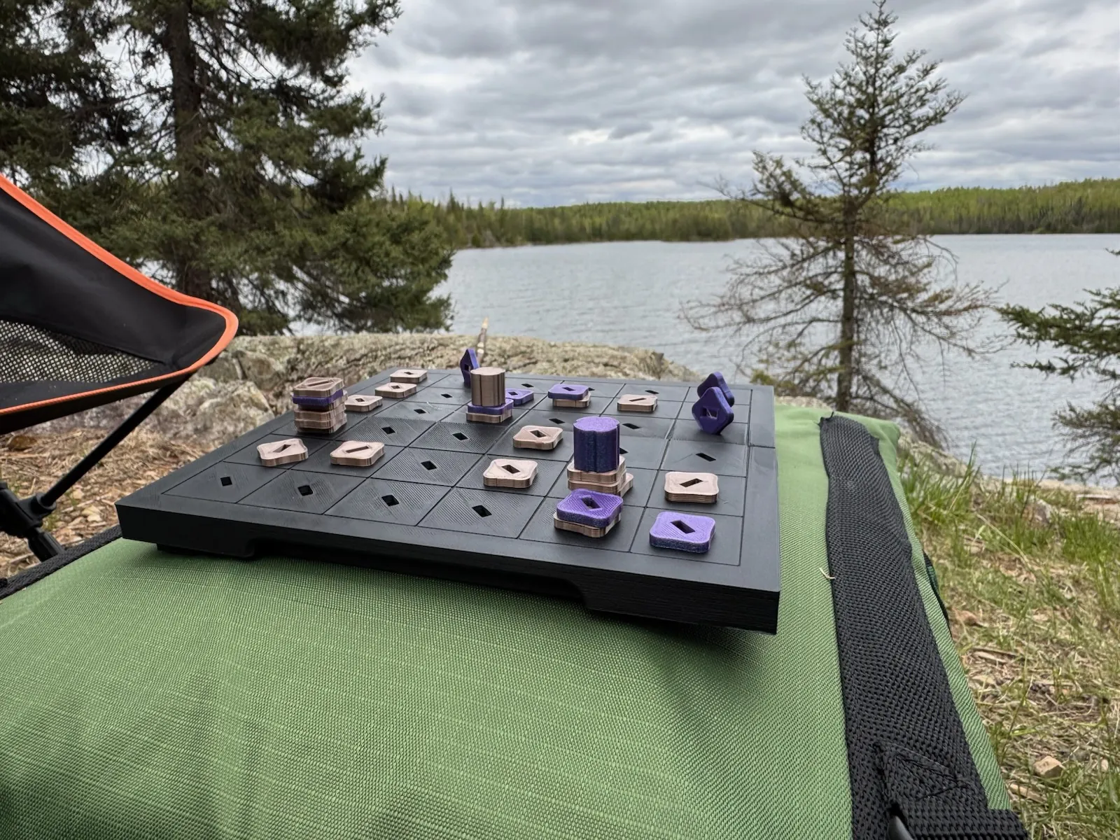Tak travel set set up on a rock beside a northern lake